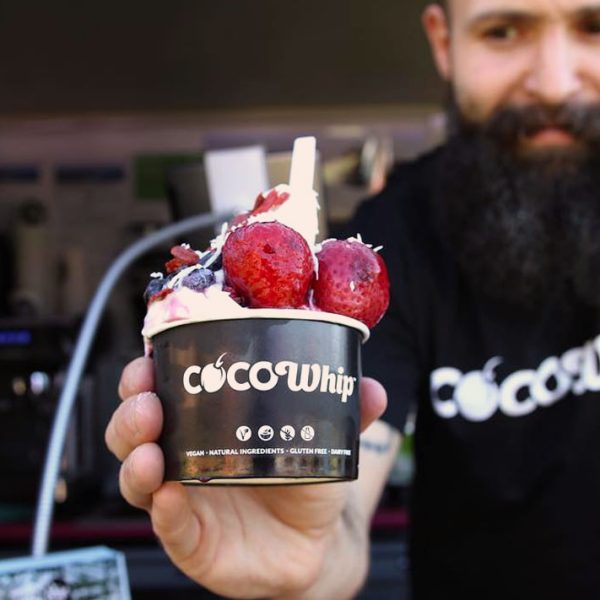 A man working in a food truck serving Cocowhip
