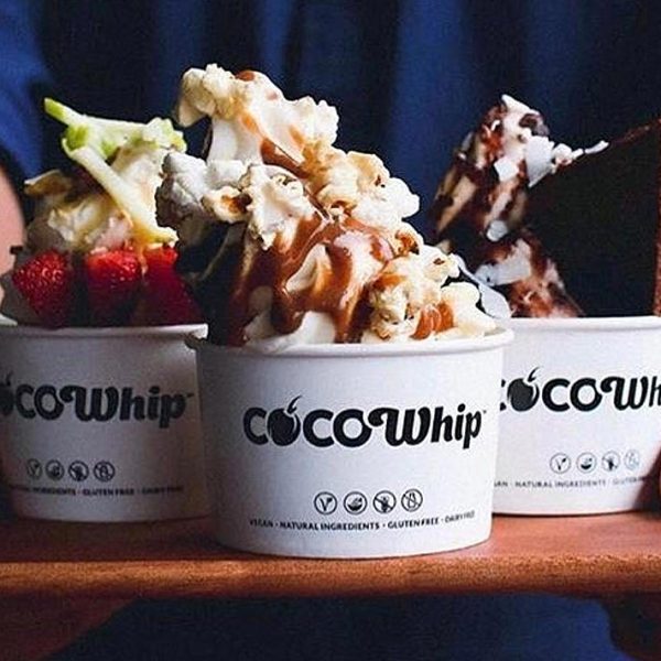 Three cocowhips on a tray with toppings