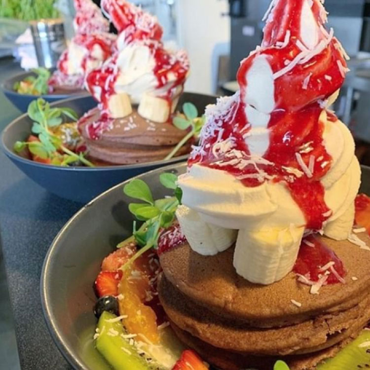 Vegan pancakes topped with Cocowhip and fresh fruit